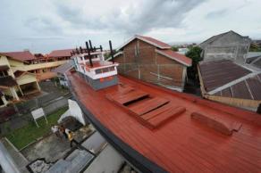 海啸袭击印尼亚齐省时，一艘渔船被冲进住宅区，成为灾民的避难所，拯救了59条宝贵生命。目前，这艘渔船已经成为海啸纪念馆，供大眾参观。（图：法新社）