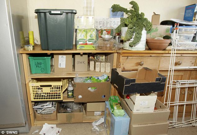 Every little helps: The Strauss family's scheme - on the top shelf is the green recycling bin, kale which they grow themselves using composted soil and plastic containers to hoard their empties. Below is a box which the family takes to the landfill site and others for recyclable newspapers, reusable plastic bags and boxes which the family uses to transport fruit and veg