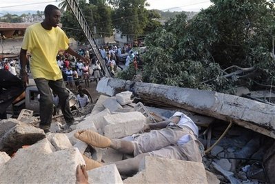 A person approaches a body lying in the rubble along Delmas road the day after an earthquake struck Port-au-Prince, Haiti, Wednesday, Jan. 13, 2010. A 7.0-magnitude earthquake, the largest ever recorded in the area, rocked Haiti on Tuesday. (AP Photo/Jorge Cruz) 
