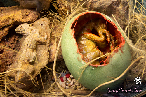 Dino in an egg (right) and lizard fossil (left) - clay art by Jamie