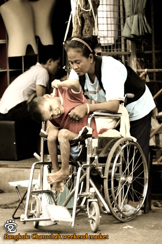 A less fortunate child and his mother at the Chatuchak weekend market