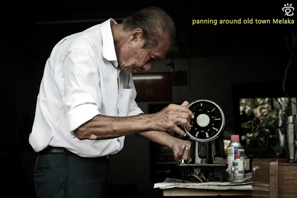 the elderly craft-man checking on a sewing maching