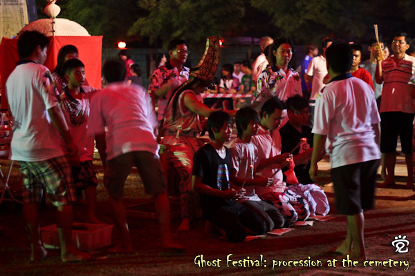 the medium of Da Ye Bo (with tall hat) giving blessing to the kneed devotees