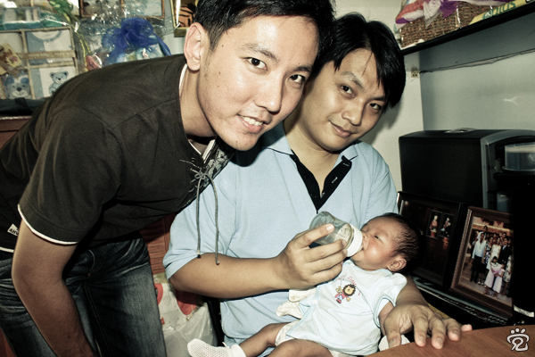 Lawrence with Mark and little Chern while milking Lawrence with Mark and little Chern while milking