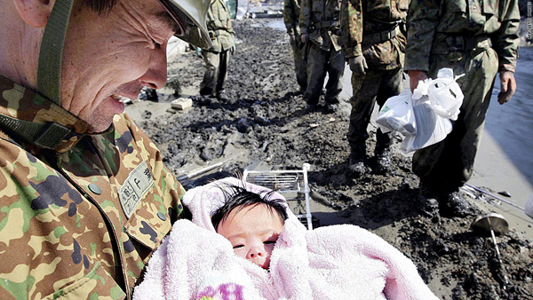 A Self Defense Forces soldier holds a 4-month-old baby in Ishinomaki city in Miyagi prefecture Monday. The child survived the tsunami with her family. (AFP/Getty photo) A Self Defense Forces soldier holds a 4-month-old baby in Ishinomaki city in Miyagi prefecture Monday. The child survived the tsunami with her family. (AFP/Getty photo)