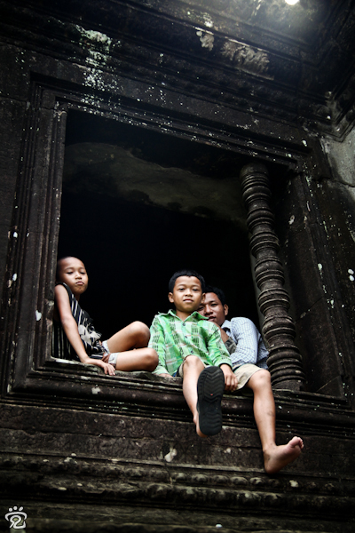 Khmer children sitting at the window of the library building of Angkor Wat