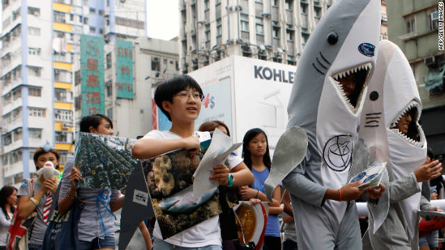 Supporters of the Hong Kong Shark Foundation march along a street to raise awareness for sharks killed each year for their fins, in Hong Kong on September 25. (image by AFP/Getty Images)