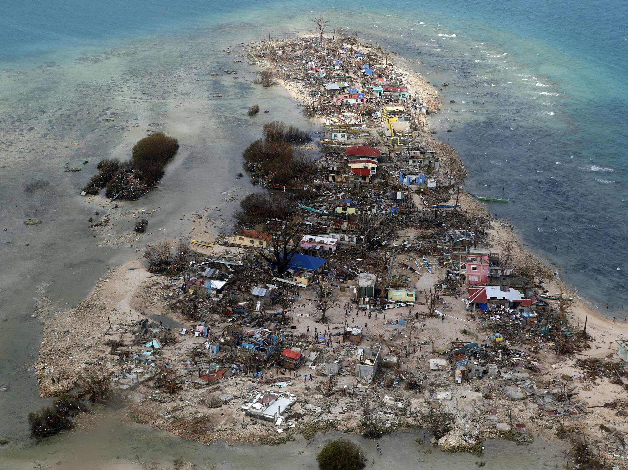 An aerial view of a coastal town, devastated by super Typhoon Haiyan, in Samar province in central Philippines November 11, 2013. Dazed survivors of super Typhoon Haiyan that swept through the central Philippines killing an estimated 10,000 people begged for help and scavenged for food, water and medicine on Monday, threatening to overwhelm military and rescue resources. (image by REUTERS/Erik De Castro)