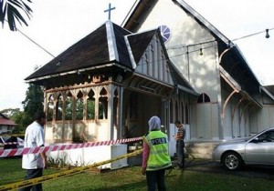 Police officers inspect damage at the All Saints Church in Taiping of Perak state, Malaysia, Sunday, Jan. 10, 2010. Another church was hit by a firebomb early Sunday, the fifth assault in three days of unrest following a court decision that allows Christians and other non-Muslims to use 'Allah' to refer to God.