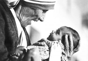 Mother Teresa smiled at a baby with love (photo from http://campusministry.georgetown.edu/)