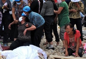 Victim crying over the lost of her family member (AP photo)