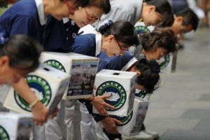 Members of the international non-profit organisation, the Buddhist Tzu Chi Foundation, bow their heads as they collect donations in Sydney (photo: AFP)