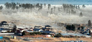 A massive tsunami engulfs a residential area in Natori, Miyagi Prefecture in northeastern Japan. (photo by Reuters/Kyodo)