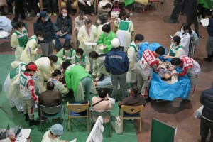 Those who have suffered near drowning are wrapped in blankets and then plastic sheeting to keep them both warm ad dry before being transported to Ishinomaki Red Cross hospital for treatment. (Photograph: Toshirharu Kato, Japanese Red Cross)