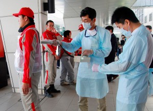 Technicians scan Red Cross rescue workers for signs of radiation in Nagahama City, Shiga Prefecture in northern Japan, after an earthquake and tsunami struck the area, March 14, 2011. (Photograph: Reuters/Kyodo)