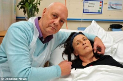 Loving: John Baillie with his wife Lorna in hospital after her miraculous recovery