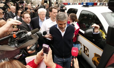 Clooney is surrounded by the media after being arrested for protesting the escalating humanitarian crisis in Sudan. (photo: REUTERS/Kevin Lamarque)