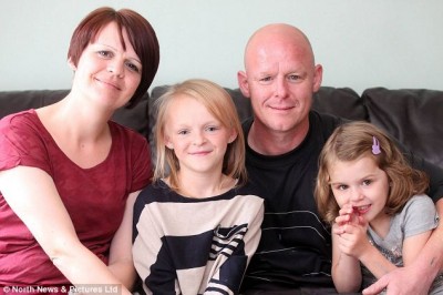 Emily Clark (left) with her parents and younger sister Lily. Emily was first diagnosed with a tumour aged two
