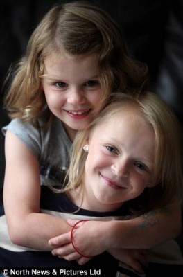 Emily Clark, 9, (right) pictured with little sister Lily has one functioning kidney